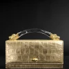 Lioness Top Handle Clutch- Gold